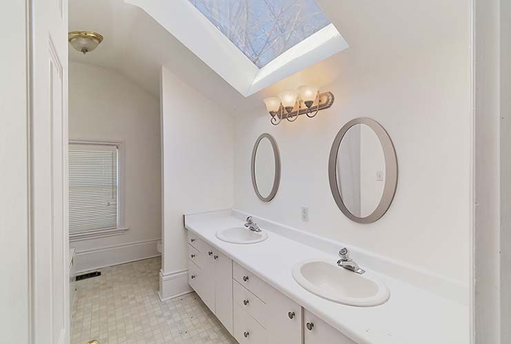 040-Skylit Upper Washroom With Tub and Dual Sink Vanity